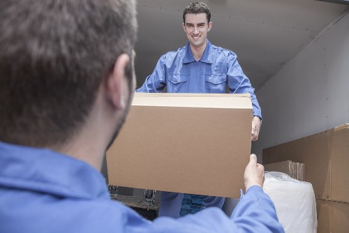 Movers team using safe lifting practices during a relocation