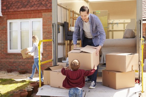 Furniture collection team handling a sofa pickup in a London flat