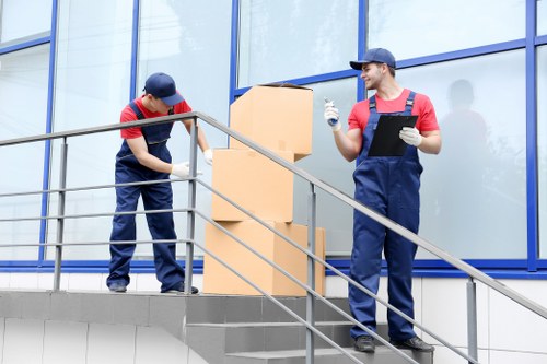 Movers planning a London home removal with boxes and furniture