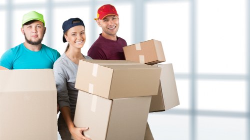 Removal team handling boxes during a London home move