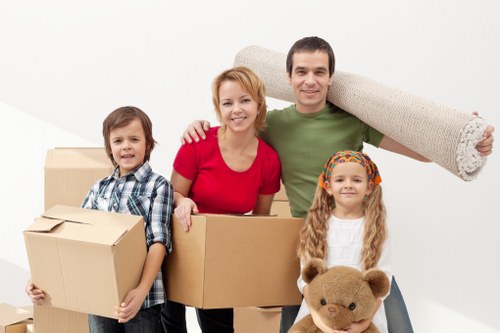 Packed moving boxes and furniture ready for collection by a London removals crew