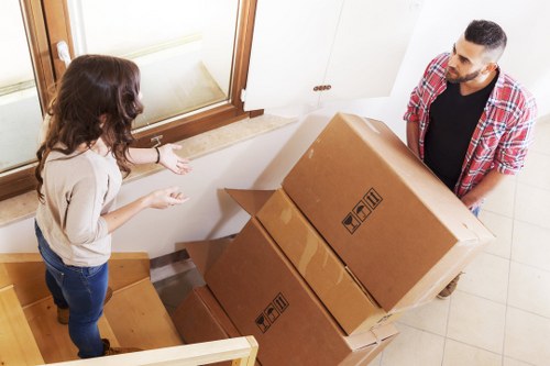 Furniture handling in a London flat with narrow stair access