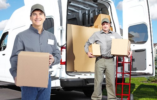 Professional movers handling boxes and furniture in London