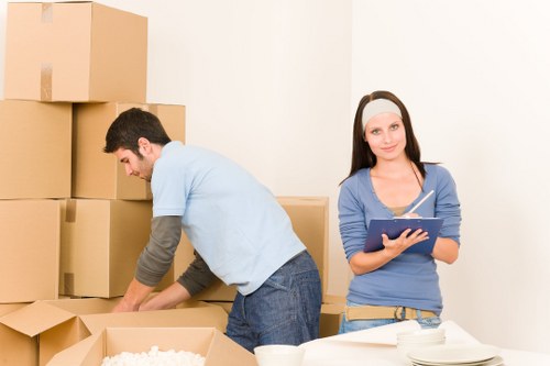 Professional movers loading items from a London flat