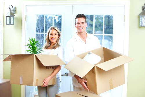 Relocation team handling desks and IT equipment during an office move